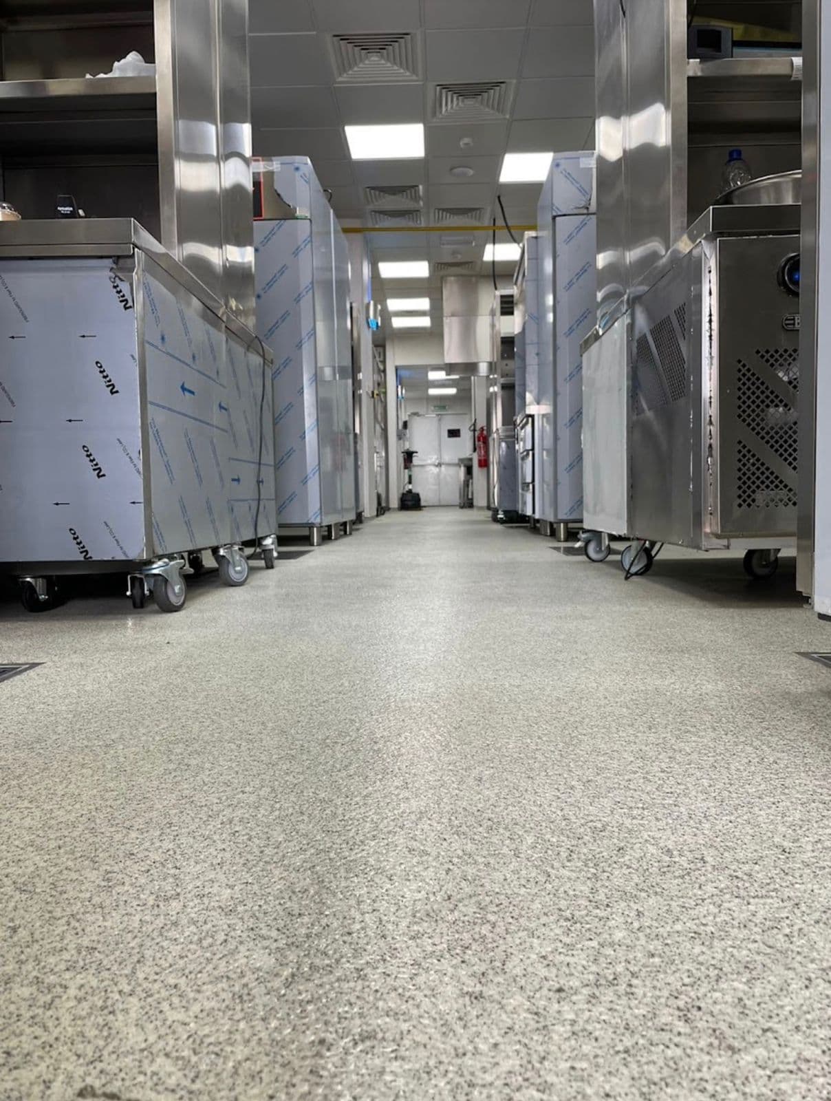 Commercial kitchen corridor with equipped stations